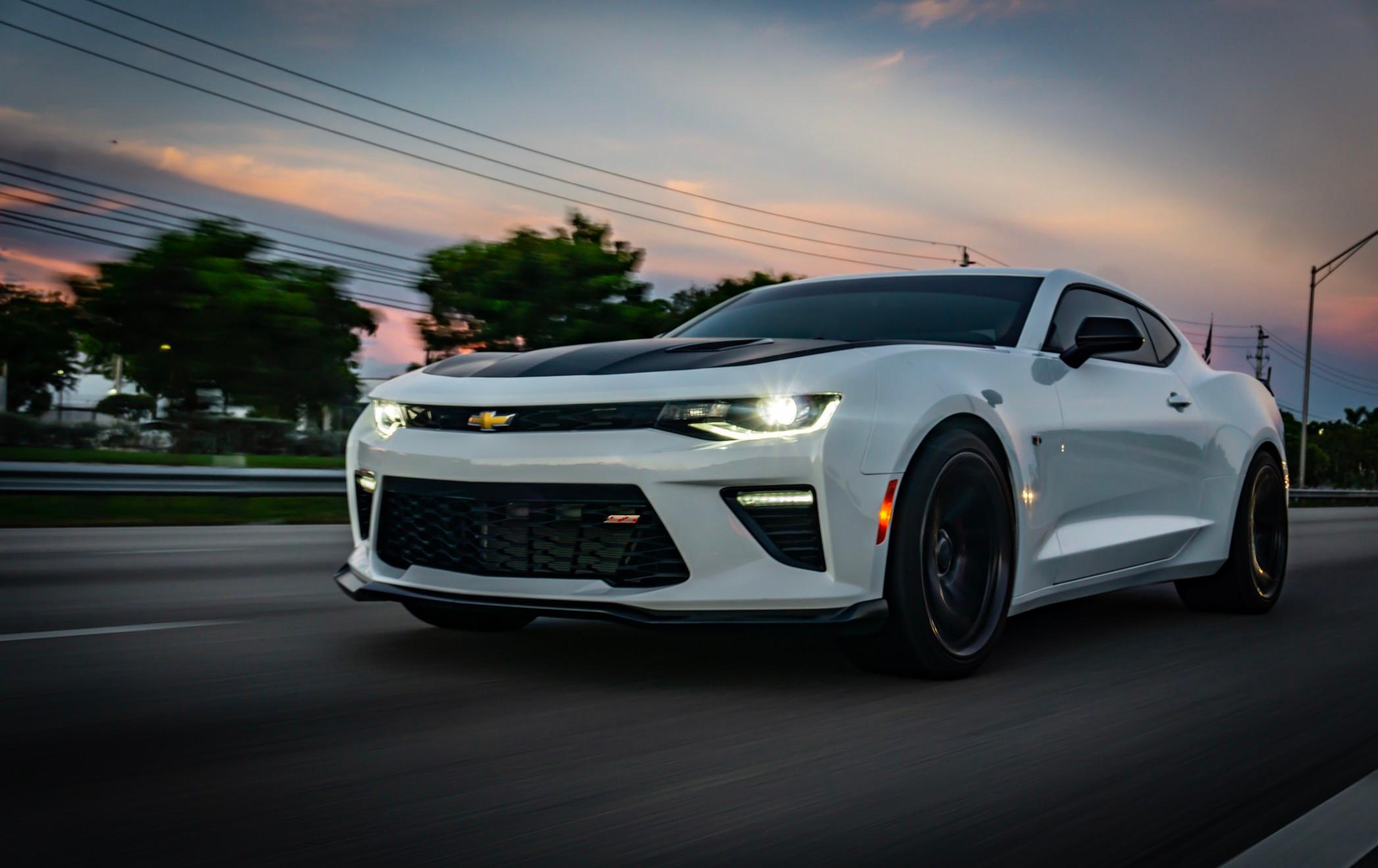 White Chevy Camaro coupe driving on a highway