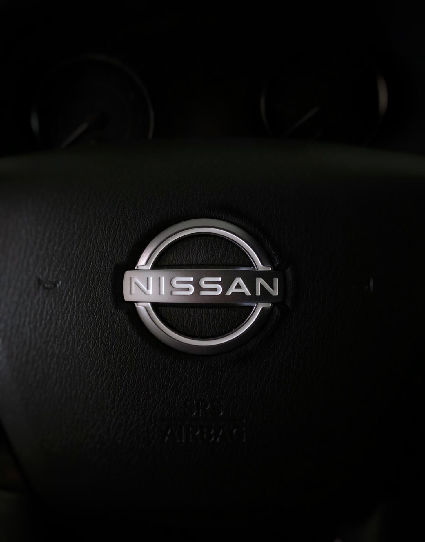 A Nissan logo set against a black background.