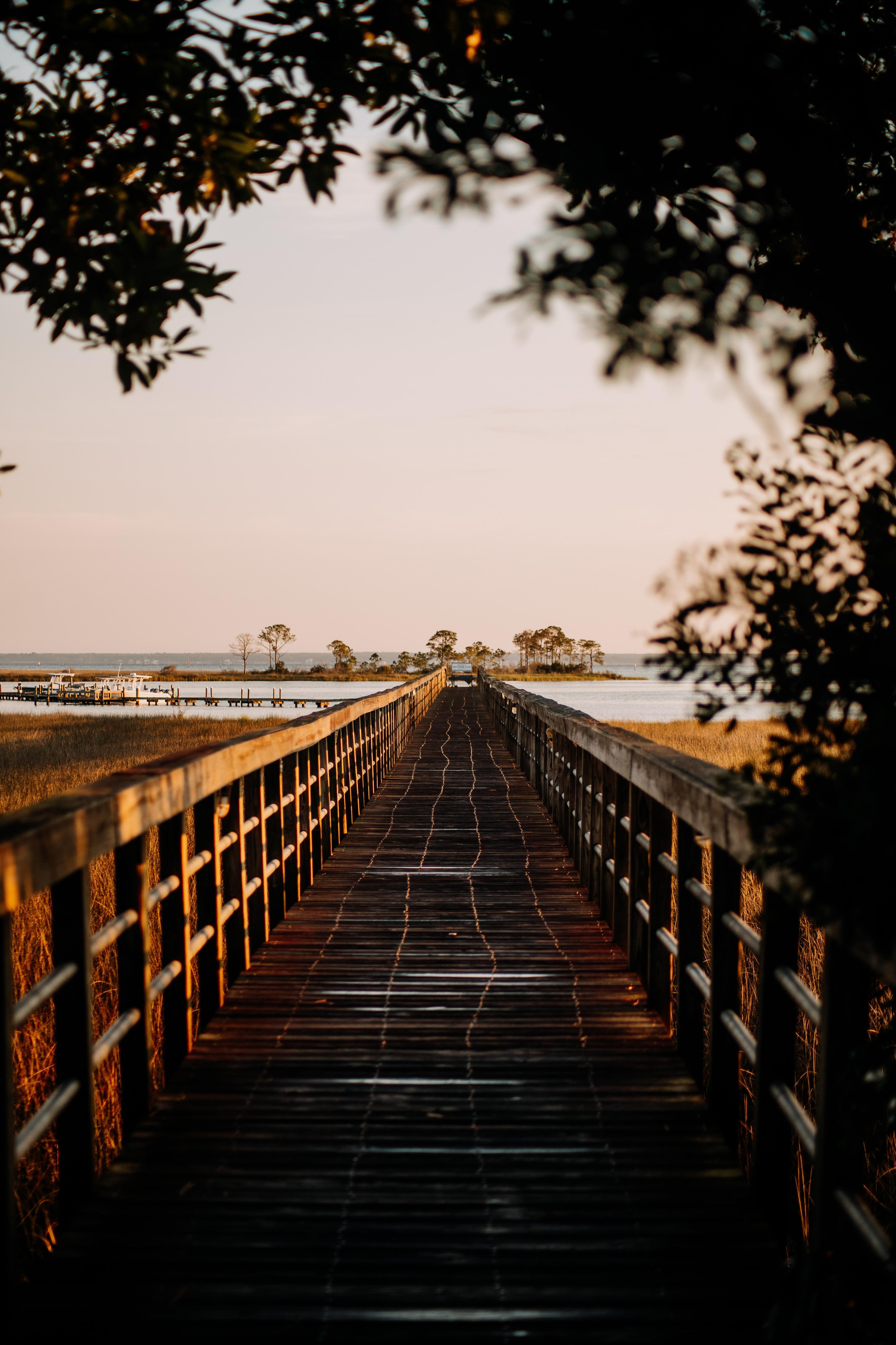 An empty bridge leading out to the water in Destin Florida.