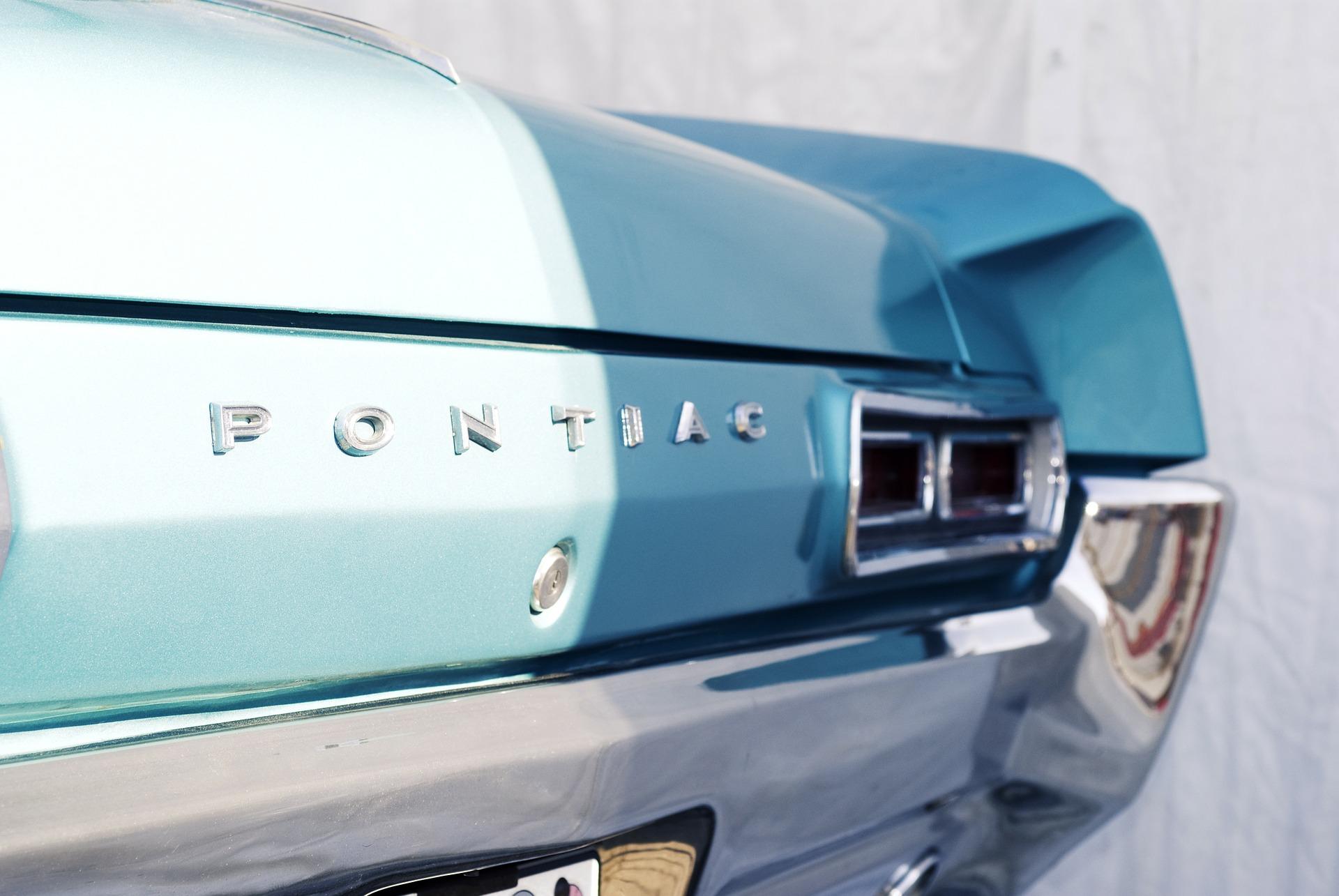 the back of a blue Pontiac 