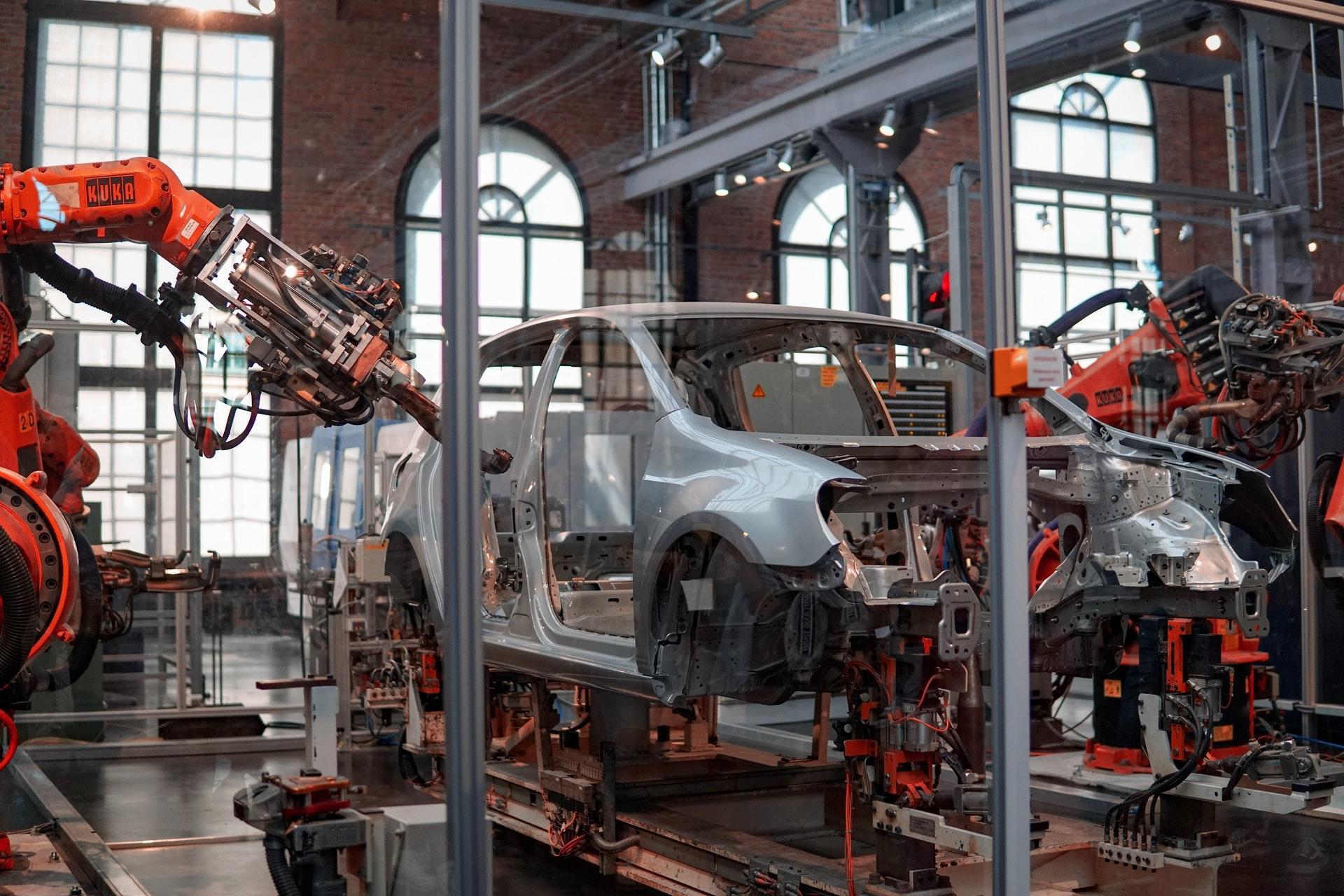 A new car being assembled in a factory.