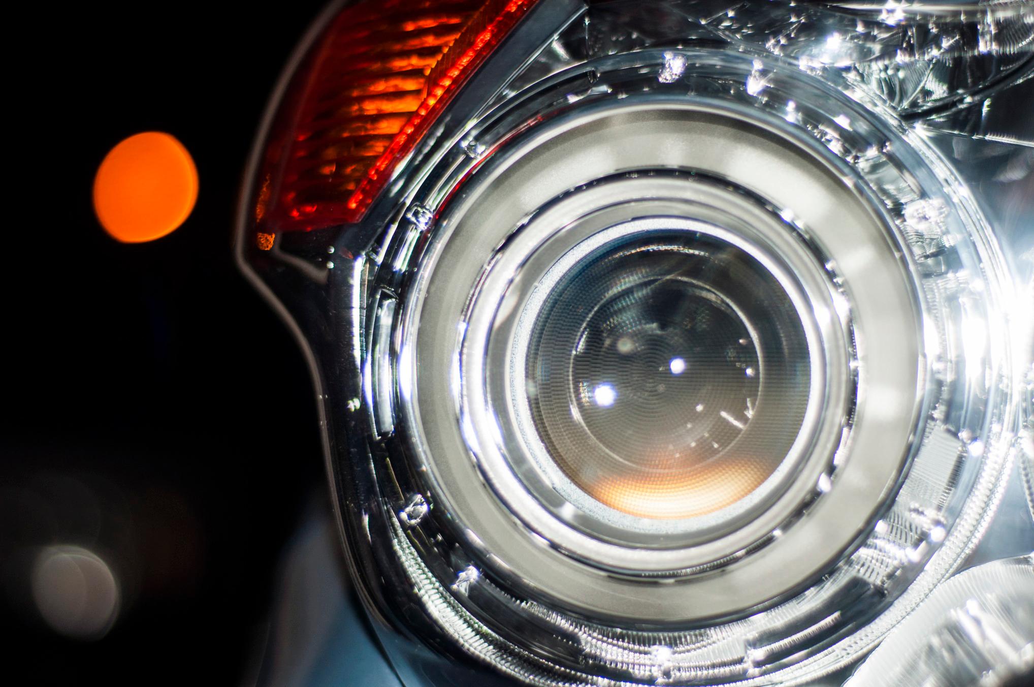 A close up shot of a headlight on a car.