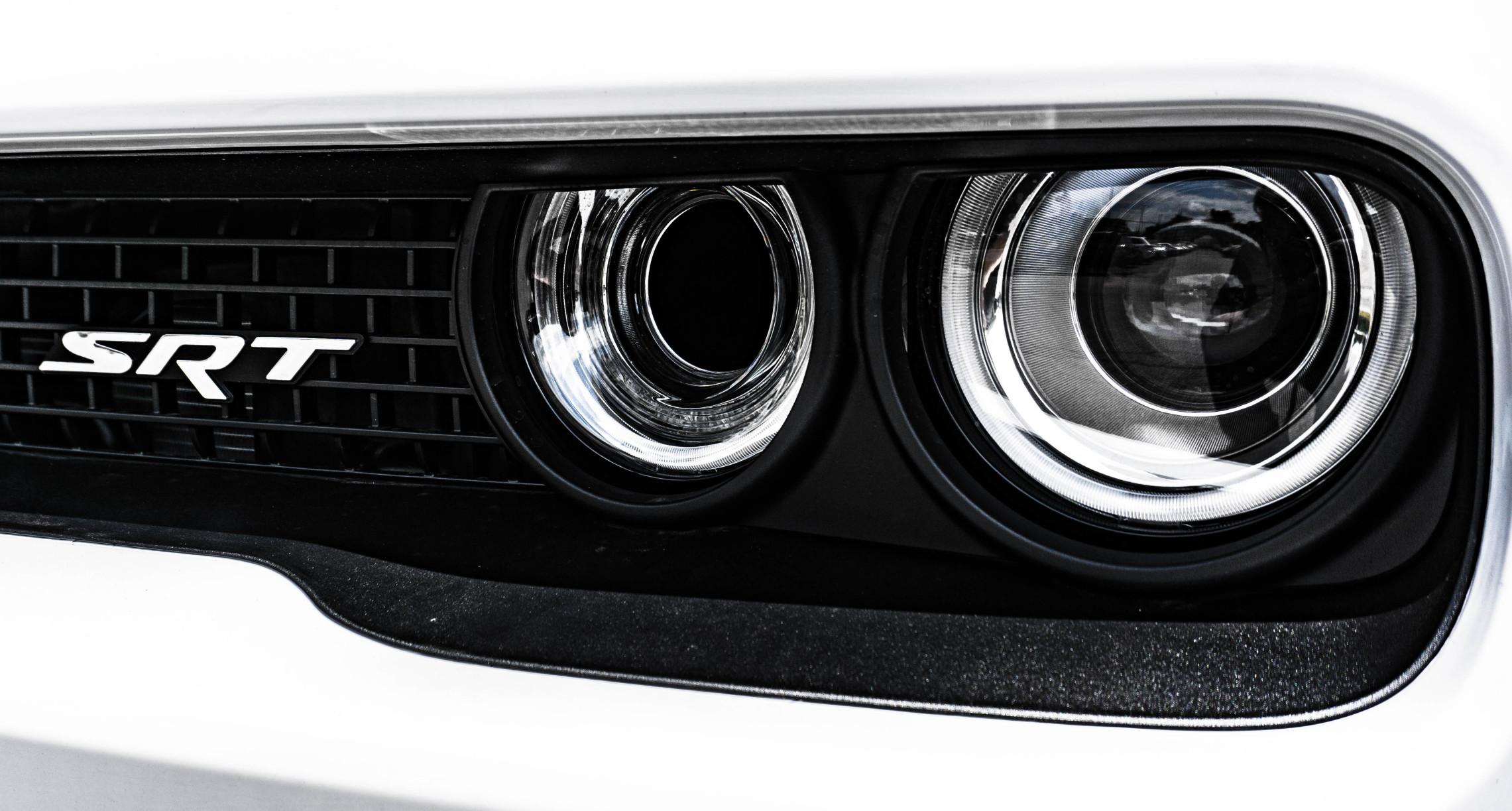 closeup of headlights on a Dodge Challenger SRT
