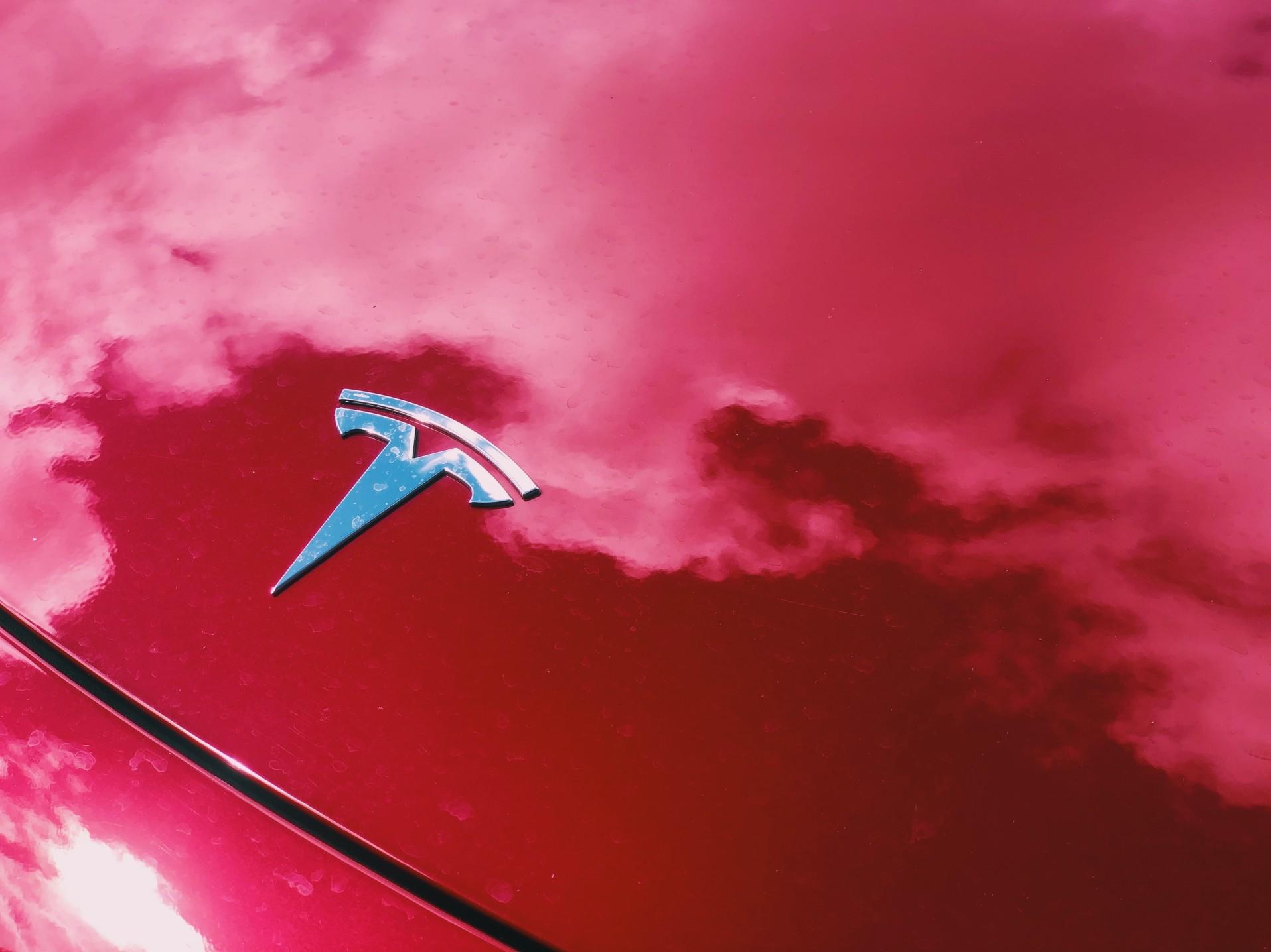 red tesla with silver logo